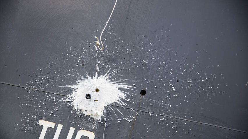 A bottle of champagne is broken against the new vessel.