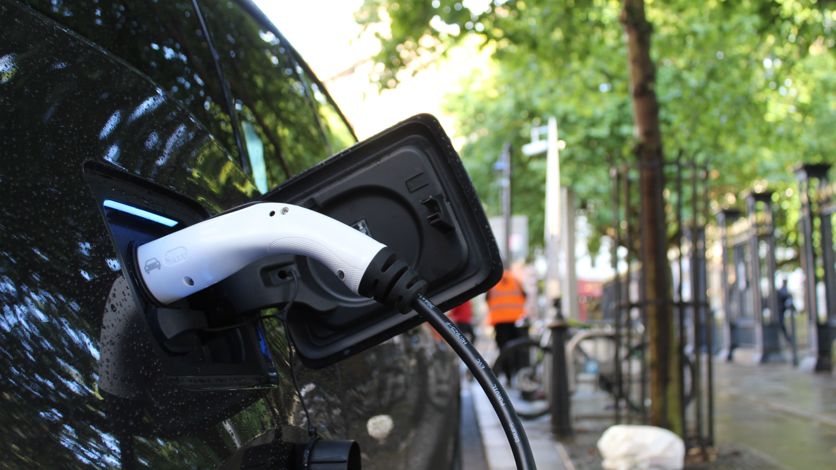 An electric vehicle being charged. An electric vehicle being charged.